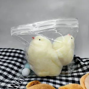 Detail view of soft yellow TPR chick squeeze toys in plastic packaging