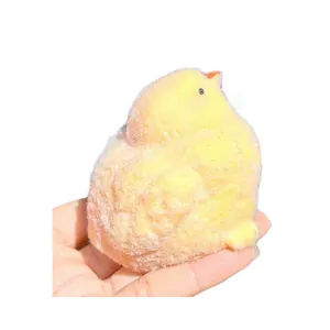 Realistic fluffy yellow chick squishy toy made of soft TPR material for stress relief.