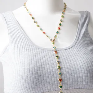 Detailed view of colorful heart-shaped glass charms on a gold-plated Y-necklace