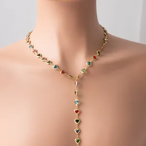 Close-up of a gold-plated Y-lariat necklace with colorful heart-shaped glass charms.