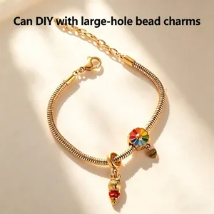 Elegant gold stainless steel DIY charm bracelet with colorful enamel flower and unique charms.