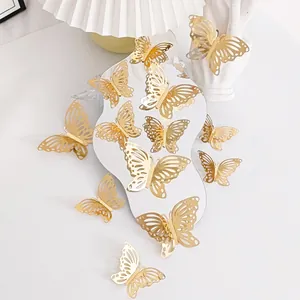 Macro detail of gold 3D hollow butterfly wall stickers displayed on a wavy mirror.