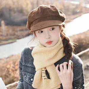 Asian woman wearing a brown corduroy newsboy cap in an outdoor autumn setting