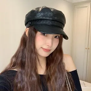 Chic vintage black newsboy cap with woven texture worn by a model in a cozy indoor setting