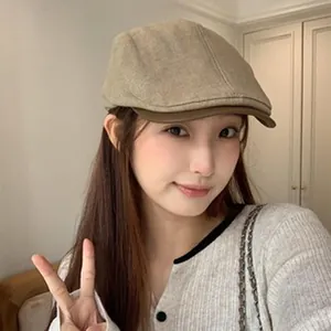 Chic Asian model wearing a British retro wool beret in beige and brown felt material