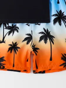 Detail of boys' swim shorts with sunset gradient and palm tree print