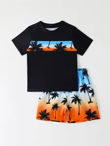 Detailed view of boys' two-piece swimwear set featuring a gradient sunset coconut tree print
