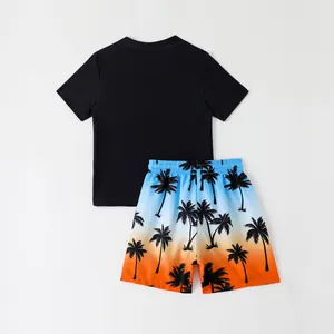 Boys' two-piece swimwear set with black rash guard and gradient palm tree shorts.