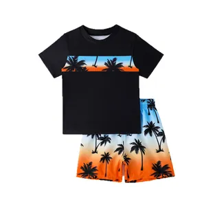 Two-piece boys swimwear set featuring black sunset palm tree t-shirt and matching shorts