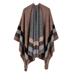 Close-up of the double-sided split poncho featuring classic earth-toned stripes.