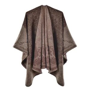 Detailed view of the vintage floral woven pattern on a warm brown double-sided shawl