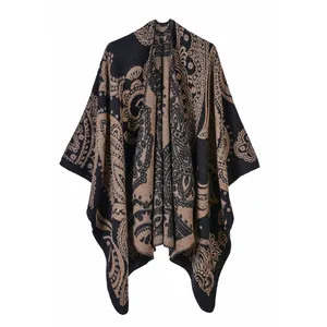 Detailed view of the intricate paisley pattern on a knit split shawl poncho