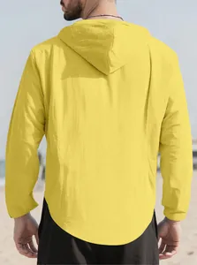 Back view of a men's loose yellow hooded pure cotton shirt for casual beach wear