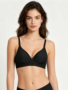 Close-up of black seamless bra with soft support and U-shaped back design on model.
