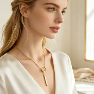 Minimalist gold plated vertical bar pendant necklace worn by a female model in elegant profile.
