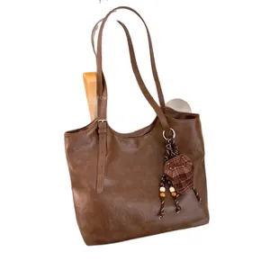 Vintage brown large capacity underarm tote bag for women with fashion charm accessory