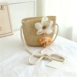 Detailed view of cute straw woven crossbody bag with white flower charm for girls