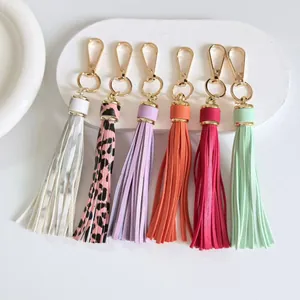 Detailed view of six colorful 10cm leather tassels with gold-tone hardware for bags