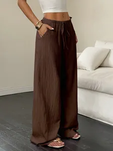Elegant brown wide-leg trousers with crinkle texture and drawstring waist for women.