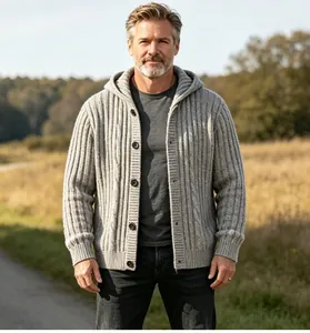 Detail shot of a grey cable knit hooded cardigan for men in a casual outdoor setting.