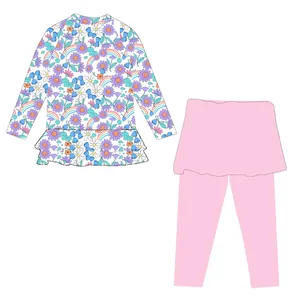 Costume da bagno due pezzi bambina con top floreale e leggings con gonnellino rosa.