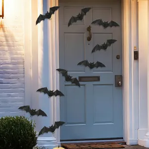 Detailed view of 3D black bat stickers on a front door for Halloween decor