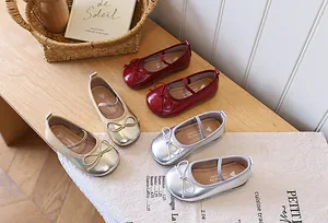 Detailed view of children's Mary Jane princess shoes in red, gold, and silver