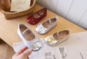 Detail of elegant girl's princess Mary Jane shoes with lovely bow detail in silver finish