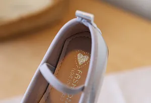 Close-up of heart print and fashion logo on girl's princess shoes inner sole