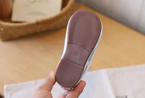 Close-up of non-slip rubber sole for toddler girl silver princess shoes, size 24.