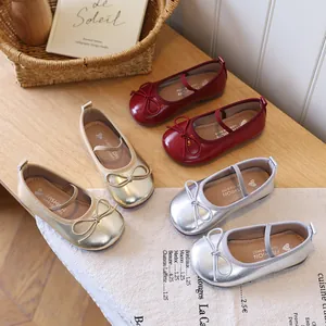 Elegant children's Mary Jane shoes with bow details in metallic gold, silver and red finish.