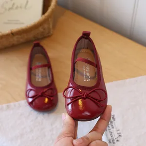 Elegant burgundy patent leather girls' princess shoes with bow detail and elastic strap