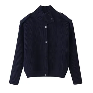 Detailed view of a dark blue high-neck knit cardigan with buttoned shoulder tabs