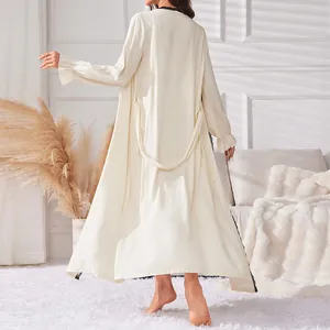 Elegant women's two-piece loungewear set with a long cream-colored robe and slip dress