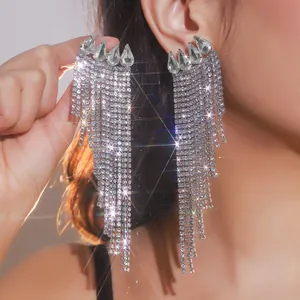Close-up detail of glamorous silver long tassel earrings with sparkling rhinestones