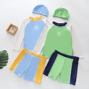 Detailed view of boys' quick-dry swimwear sets in light blue and green colorways