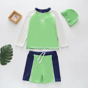 Three-piece children's long-sleeve swimwear set in green and white with sun design