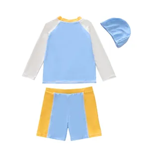 Three-piece boys' swimwear set with long-sleeve top, shorts and cap in blue and yellow