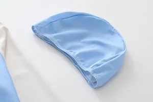 Close-up detail of a light blue quick-drying swim cap for boys in a swimwear set