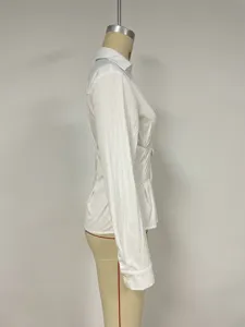 Side view detail of a white slim-fit long-sleeve shirt on a mannequin