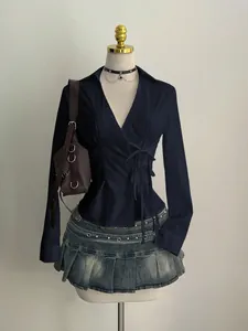 Detailed view of navy blue V-neck long sleeve shirt with unique side lace-up tie design
