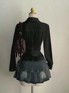 Detailed back view of a slim-fit black long-sleeved blouse displayed on a mannequin