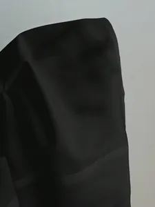 Detailed view of the smooth black fabric texture and seams on a women's shirt