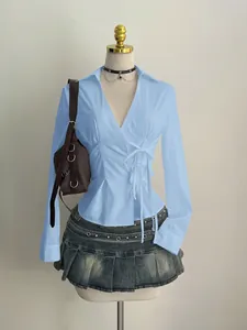 Elegant light blue long-sleeved wrap shirt for women with waist-slimming tie design