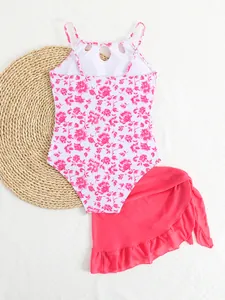 Girls' floral print one-piece swimsuit paired with a pink ruffled mesh wrap skirt