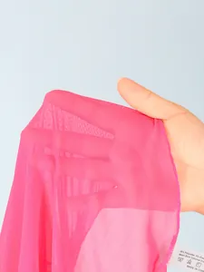 Detail shot showing the high-quality breathable pink mesh fabric of the girls' swimsuit skirt