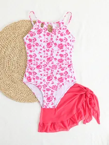 Detailed view of girls' floral print one-piece swimsuit with matching pink mesh ruffle skirt.