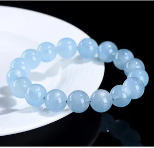 Detailed macro view showing the natural internal texture of light blue aquamarine round beads