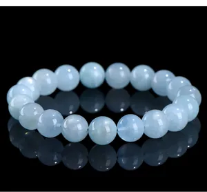 Detailed close-up of a natural light blue aquamarine beaded bracelet with glossy reflections