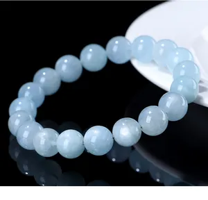 Close-up detail of a natural starlight aquamarine bead bracelet with smooth blue finish